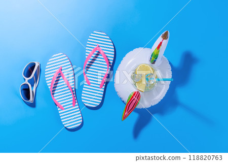 A vibrant summer vacation scene with flip flops, and a floating flamingo A vibrant summer vacation scene with flip flops, and a floating flamingo 118820763