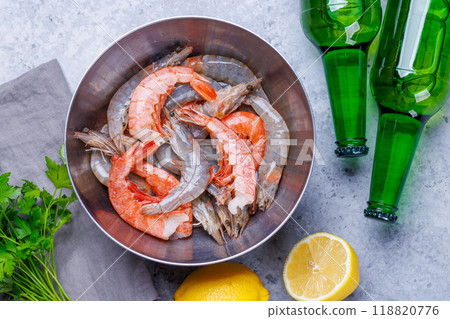 Fresh raw shrimps, accompanied by sprigs of fresh parsley and juicy lemon Fresh raw shrimps, accompanied by sprigs of fresh parsley and juicy lemon 118820776