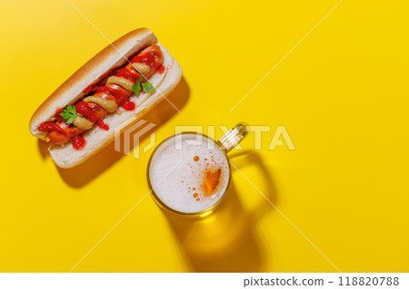 A vibrant photo showcasing a glass of beer and classic hot dog 118820788