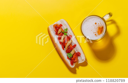 A vibrant photo showcasing a glass of beer and classic hot dog 118820789