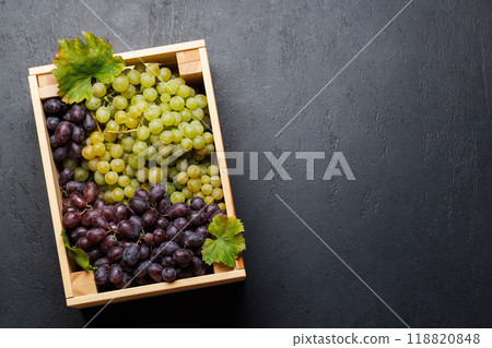 A wicker basket brimming with a variety of grapes 118820848
