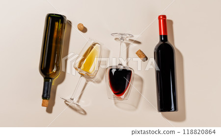 Two wine glasses alongside a bottles and several corks 118820864