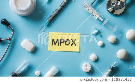 Mpox label surrounded by medical items on a blue surface. Concept of healthcare response and viral prevention. Mpox label surrounded by medical items on a blue surface. Concept of healthcare response and viral prevention. 118821432