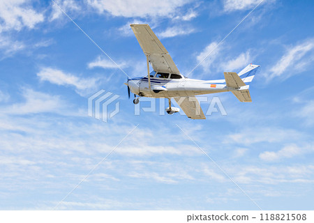 Single engine ultralight plane flying in the blue sky with white clouds Single engine ultralight plane flying in the blue sky with white clouds 118821508