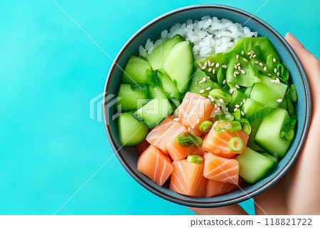 Salmon and cucumber bowl with rice on teal 118821722
