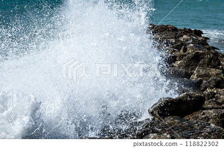 Close-up of sea waves breaking on the rocks of Vilanova y la Geltru beach	 118822302