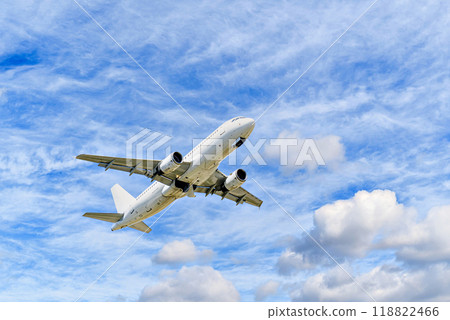 Passenger plane landing at the airport, under a blue sky with white clouds Passenger plane landing at the airport, under a blue sky with white clouds 118822466
