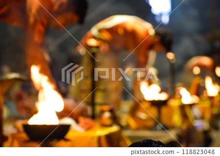 Pujaris or Indian priests performing Aarti ceremony on banks of Ganges in crowd 118823048
