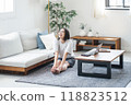 Woman stretching in the living room at home 118823512