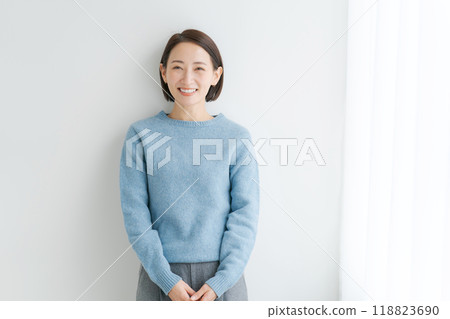 Woman wearing blue knitwear Woman wearing blue knitwear 118823690