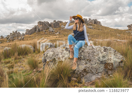 A Woman traveling through the peruvian andes. Huayllay Stone Forest, Peru. A Woman traveling through the peruvian andes. Huayllay Stone Forest, Peru. 118823977