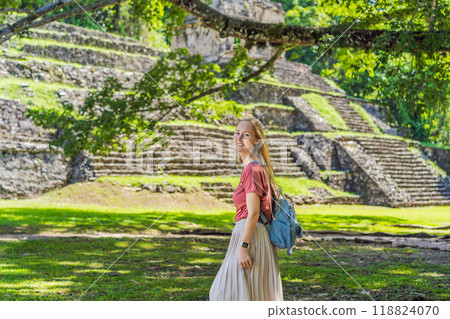 Female tourist exploring the ancient pyramids of Palenque, Mexico, surrounded by dense jungle. Cultural heritage and adventure travel concept Female tourist exploring the ancient pyramids of Palenque, Mexico, surrounded by dense jungle. Cultural heritage and adventure travel concept 118824070