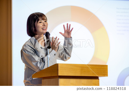 A woman giving a seminar in work clothes. Photo courtesy of Denpa Gakuen, Tokyo Electronics College. A woman giving a seminar in work clothes. Photo courtesy of Denpa Gakuen, Tokyo Electronics College. 118824318