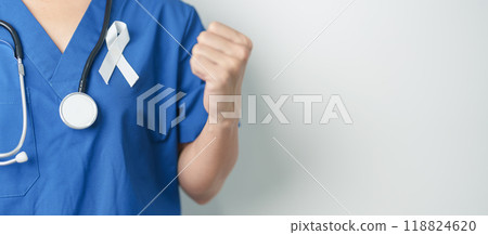 November Lung Cancer Awareness month and Stop Violence Against Women. Doctor with White ribbon in hospital. Healthcare and World Cancer day concept November Lung Cancer Awareness month and Stop Violence Against Women. Doctor with White ribbon in hospital. Healthcare and World Cancer day concept 118824620