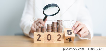 2024 end year to Happy New Year 2025 with coins money stack growing with magnifier glass. Money saving, Inflation, tax, cash flow, Job search, hiring and research development concepts 2024 end year to Happy New Year 2025 with coins money stack growing with magnifier glass. Money saving, Inflation, tax, cash flow, Job search, hiring and research development concepts 118825370
