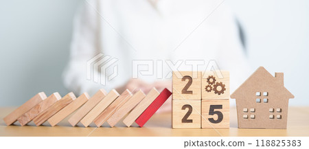 2025 year with wood block falling to Home model and business icon. Real estate Mortgage, Refinance, House loan and debt, Interest rate, Insurance, Financial Property and economic recession 118825383