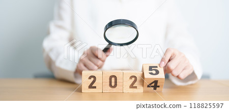 2024 end year to Happy New Year 2025 with magnifying glass and people. hiring, employee, recruitment, job, SEO and jobless concept 118825597