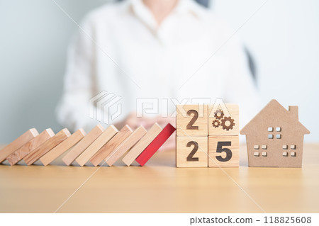 2025 year with wood block falling to Home model and business icon. Real estate Mortgage, Refinance, House loan and debt, Interest rate, Insurance, Financial Property and economic recession 118825608