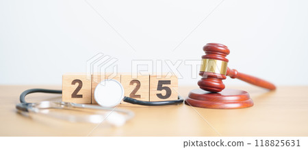 Happy New Year 2025 with Stethoscope of doctor and Judges gavel on table. health care Law, Insurance, Wellness, medical Tax, cost, Auction and Bidding concepts Happy New Year 2025 with Stethoscope of doctor and Judges gavel on table. health care Law, Insurance, Wellness, medical Tax, cost, Auction and Bidding concepts 118825631