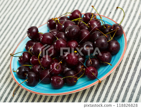 Closeup of fresh tasty red berries cherry on plate 118826828