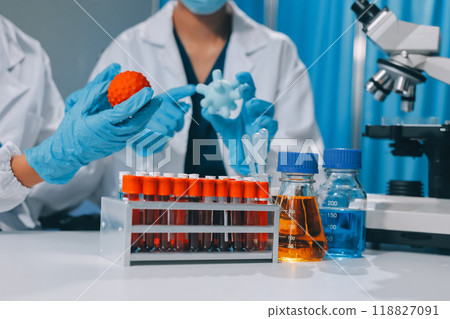 Scientist using microscope in laboratory. Close-up of a researcher's hands adjusting a modern microscope in a lab setting. Science concept Scientist using microscope in laboratory. Close-up of a researcher's hands adjusting a modern microscope in a lab setting. Science concept 118827091