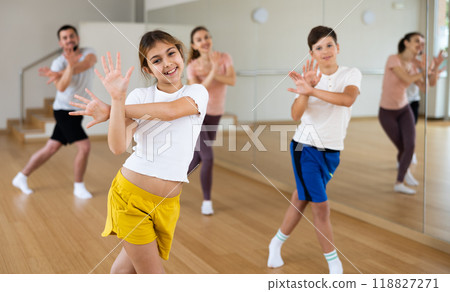 Girl exercising during family dance class 118827271