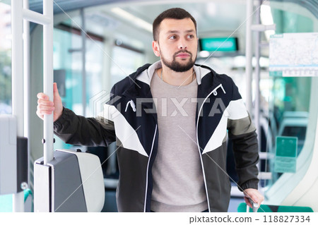 Portrait of male passenger in tram car on spring day 118827334