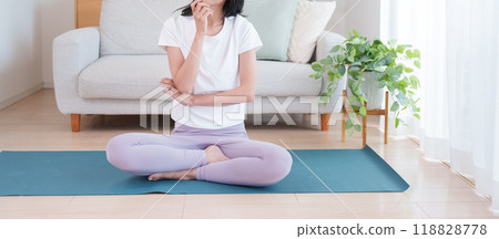 A thinking woman wearing yoga wear A thinking woman wearing yoga wear 118828778