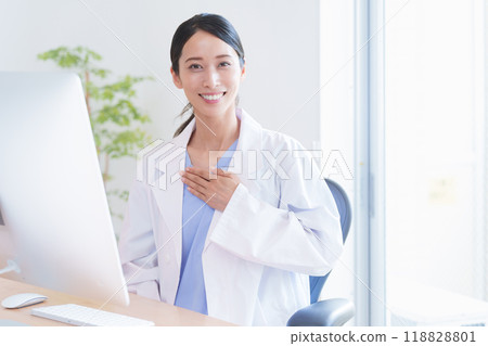 Female doctor putting her hand on her chest 118828801