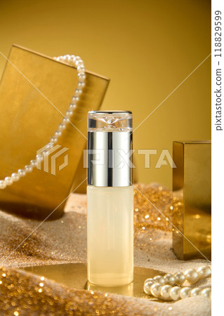 The photography of luxury theme was shot from close up front view. Unbranded cosmetic bottle displayed in center, gold and jewelry decorated in back. Blank space for design and adding text 118829599