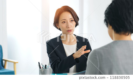 Two female business people consulting in the office 118830505