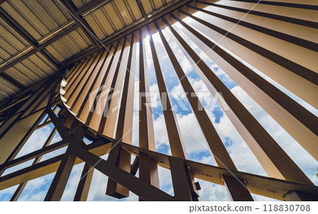 A structure featuring wooden slats on construction site contributing to its architectural style A structure featuring wooden slats on construction site contributing to its architectural style 118830708