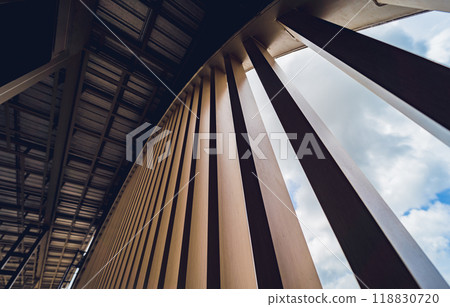 A structure featuring wooden slats on construction site contributing to its architectural style 118830720