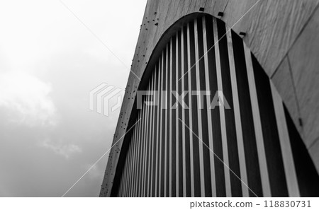 A structure featuring wooden slats on construction site contributing to its architectural style. A structure featuring wooden slats on construction site contributing to its architectural style. 118830731