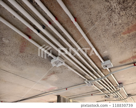 The electrical wiring at the construction site is completed and suspended from the ceiling The electrical wiring at the construction site is completed and suspended from the ceiling 118830739