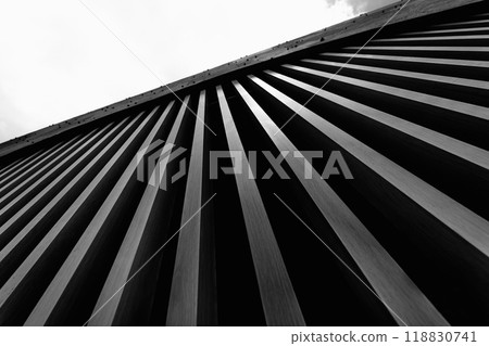 A structure featuring wooden slats on construction site contributing to its architectural style 118830741