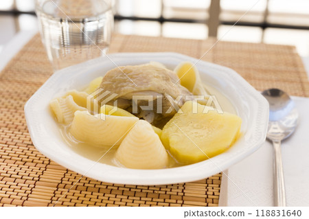 Chicken broth soup with chicken, potatoes, and pasta shells 118831640