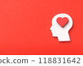 A person with a heart symbol in his brain and a red background with text space 118831642