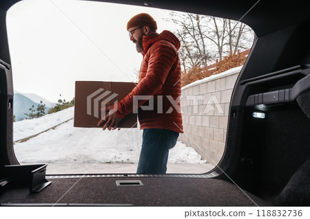 Man buying christmas gifts during winter, bringing box home. Mature man moving to the new house, packing into cardboard box. 118832736