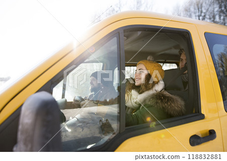 Friends traveling by car on winter holiday, spending Christmas in cabin. Driving through snowy landscape. Friends traveling by car on winter holiday, spending Christmas in cabin. Driving through snowy landscape. 118832881