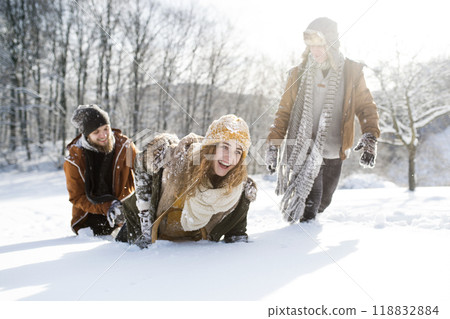 Friends in snowball fight in snowy nature. First snowfall of the season. Friends in snowball fight in snowy nature. First snowfall of the season. 118832884