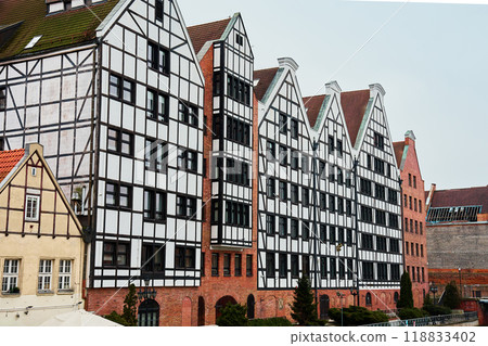 Row of colorful half timbered buildings with gabled roofs in old town of Gdansk, Poland. Living house facade with balconies. Apartment building. Mortgage in real estate 118833402
