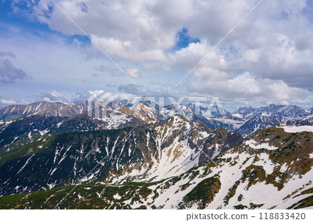 Panoramic view of snow-capped mountain range against cloudy sky. Tatra mountains in Zakopane, Poland. Giewont mountain summit. Natural landscape 118833420