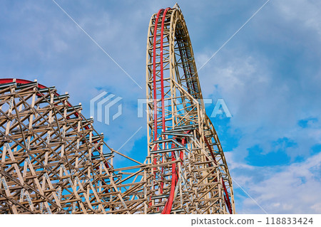 Roller coaster attraction in amusement park. Entertainment at summer holiday Roller coaster attraction in amusement park. Entertainment at summer holiday 118833424