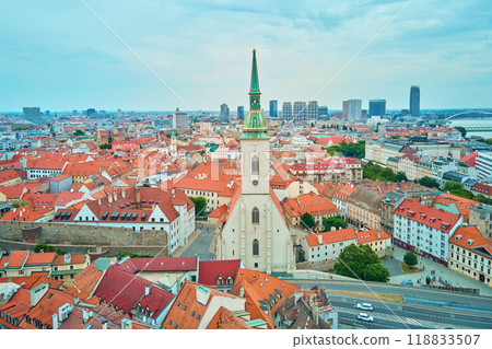 Panorama of Bratislava, Slovakia. Aerial view of historic European city with vibrant red rooftops. Urban landscape with historical buildings Panorama of Bratislava, Slovakia. Aerial view of historic European city with vibrant red rooftops. Urban landscape with historical buildings 118833507