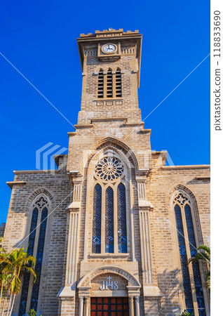 Tower on Nha Trang Cathedral or Stone Catholic Church or Christ the King Cathedral in Vietnam against blue sky background Tower on Nha Trang Cathedral or Stone Catholic Church or Christ the King Cathedral in Vietnam against blue sky background 118833690