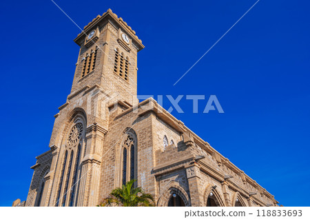 Tower on Nha Trang Cathedral or Stone Church or Christ the King Cathedral in Vietnam against blue sky background Tower on Nha Trang Cathedral or Stone Church or Christ the King Cathedral in Vietnam against blue sky background 118833693