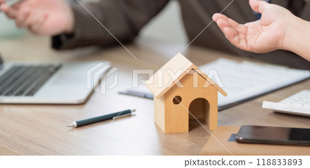 Real Estate Negotiation Over Property Contract and House Model 118833893