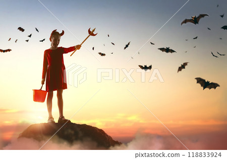 girl in devil costume at Halloween 118833924