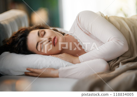 woman is sleeping in the bedroom 118834005